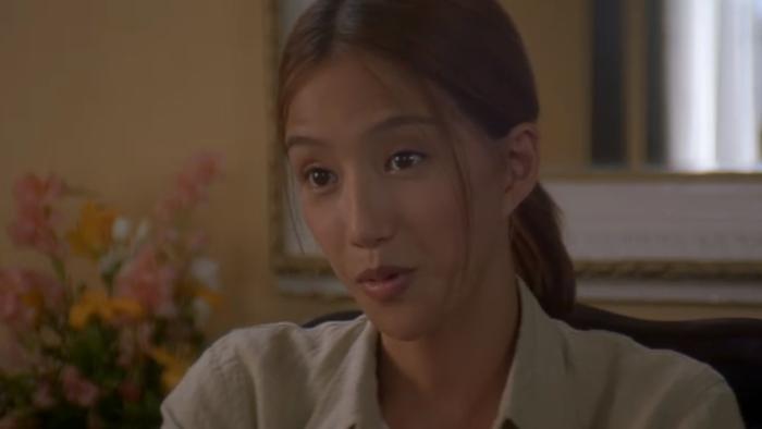 The Accidental Spy: Min Kim sits in chair