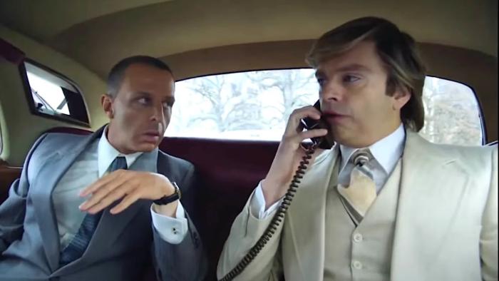 The Apprentice Movie: In the back seat of a car, Roy Cohn is guiding Donald Trump during a cell phone call