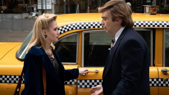 The Apprentice Movie: Ivana (Maria Bakalova) and Donald Trump (Sebastian Stan) talk in front of a taxi