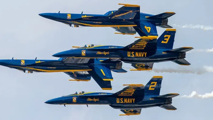 The Blue Angels: Jets flying into diamond formation.