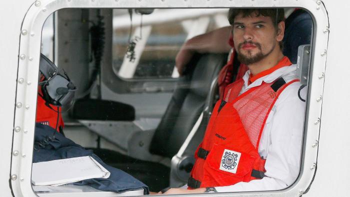 The Carman Family Deaths movie: Nathan Carman in orange vest pictured sitting in a rescue helicopter