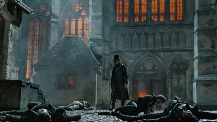 The Count of Monte Cristo (2024) movie: Edmond Dantes surveys the scene of robbers lying on the ground after "saving" Albert's life