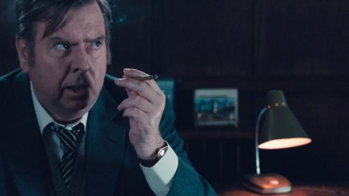 The Damned United: Timothy Spall smokes cigar at desk