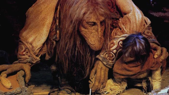 The Dark Crystal Movie: A large, hunchbacked creature bows its head closely with another smaller, child-like creature