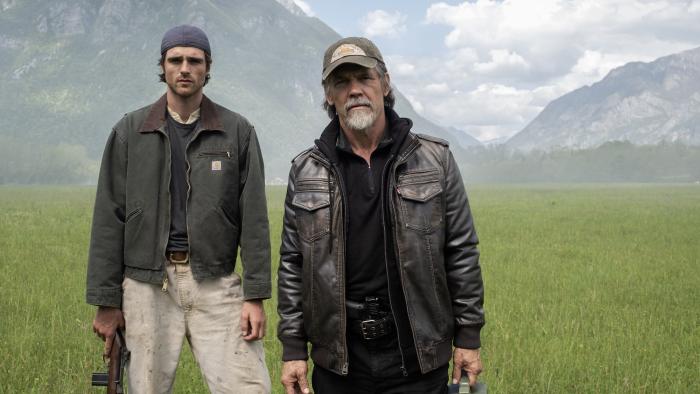 The Dog Stars movie: Jacob Elordi holds a rifle and Josh Brolin holds a gas can, standing in front of mountains