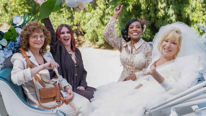 The Fabulous Four movie: Susan Sarandon, Megan Mullally, Sheryl Lee Ralph, and Bette Midler sit together at a wedding