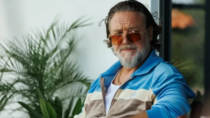 The Get Out: Man in sunglasses and tracksuit, sitting outdoors, with plants nearby