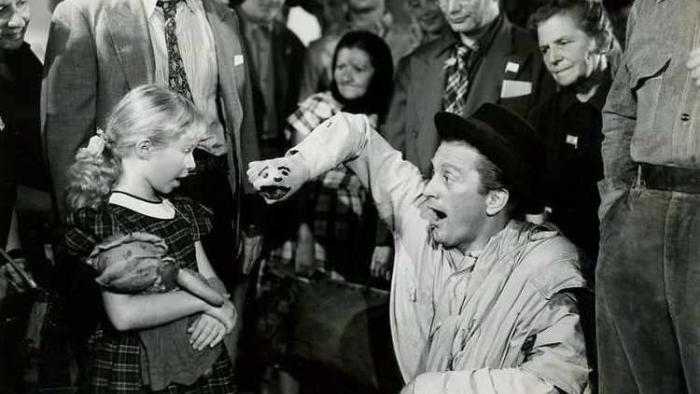 The Juggler: Kirk Douglas entertains a child at a refugee camp