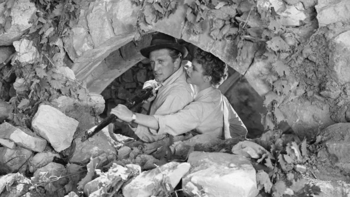 The Juggler: Kirk Douglas holds a rifle while Milly Vitale tries to point it down