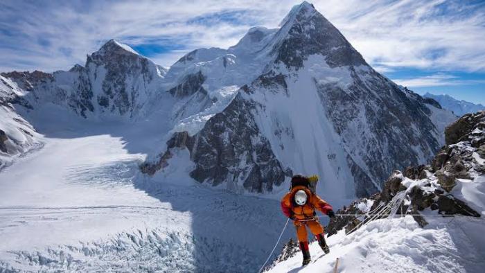 The Last First: Winter K2: Climber by a peak.