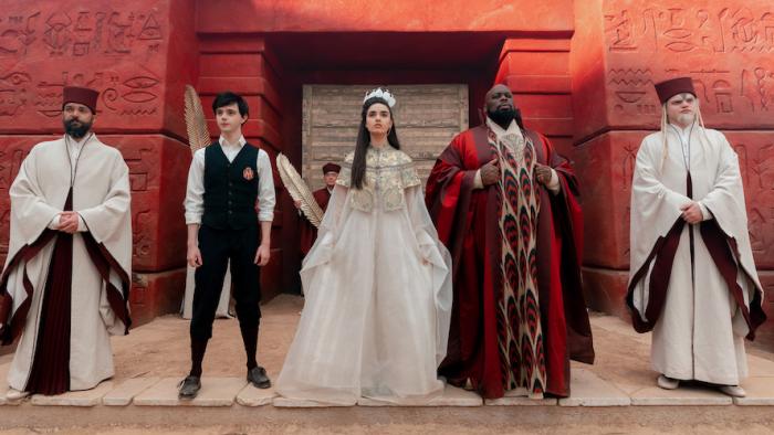The Magic Flute Movie: Five members of the court -- Prince Tremino, the queen, and the king, stand facing the court