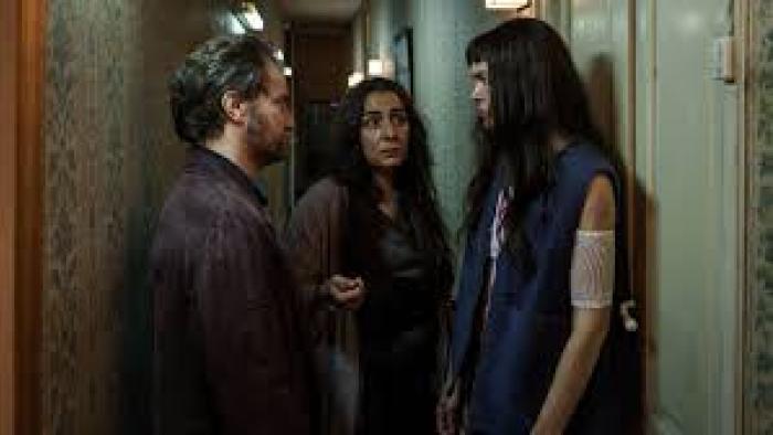 The Marked Woman: Three people face off in a hallway.