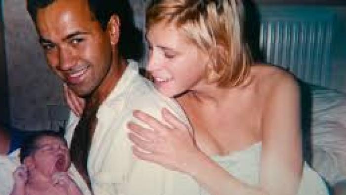 The Murder of Rachel Nickell: Couple smiling with newborn baby in a cozy room.