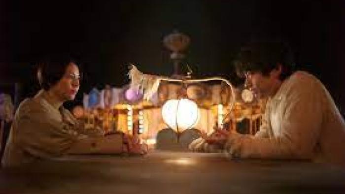 The Parades: group sits around light