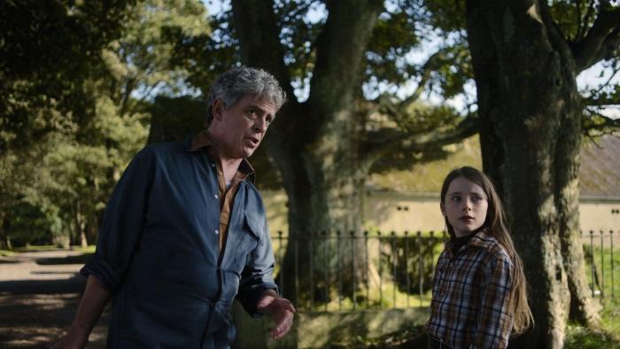 The Quiet Girl: A man with graying hair and a young girl stand together in the countryside