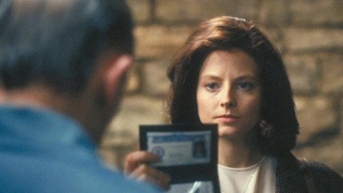 The Silence of the Lambs movie: Clarice holds up her FBI badge to a man in the doorway