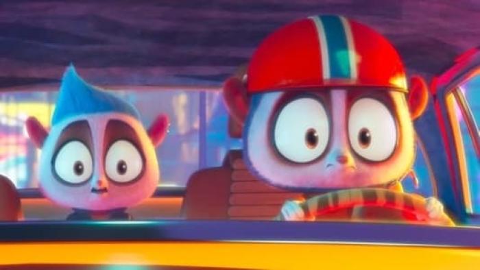 Rally Road Racers Movie: Two animated creatures with big eyes sit in a car, one steering and one in the back seat