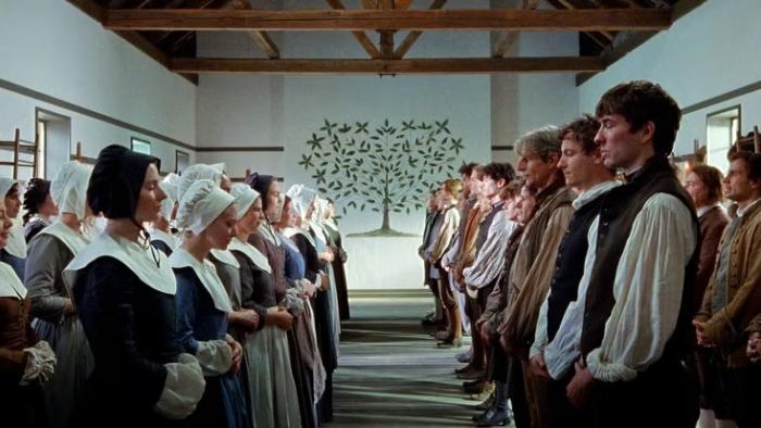 The Testament of Ann Lee movie: Shakers line up, women facing men, with the Shaker drawing of a tree centered on the wall between 