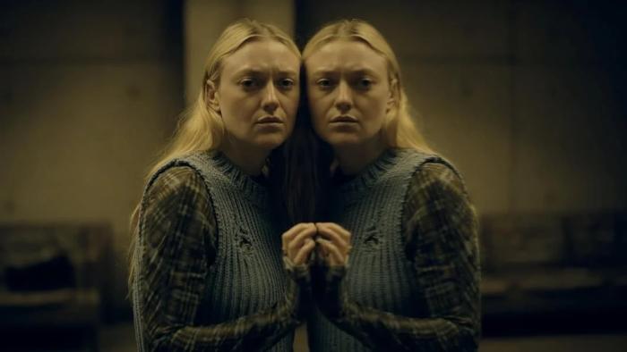 The Watchers Movie: Dakota Fanning leans against a mirror