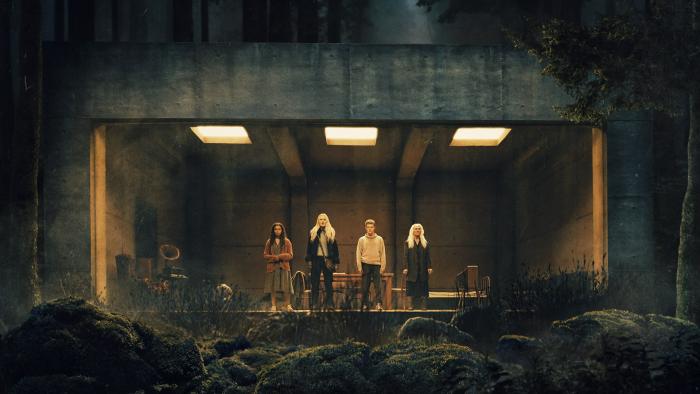 The Watchers Movie: Four people stare out of a large glass window