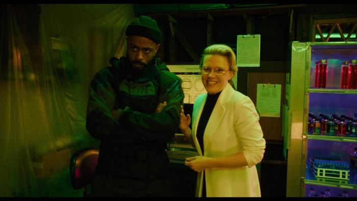 The Wrong Girls movie: LaKeith Stanfield stands next to Kate McKinnon, who's wearing a lab coat