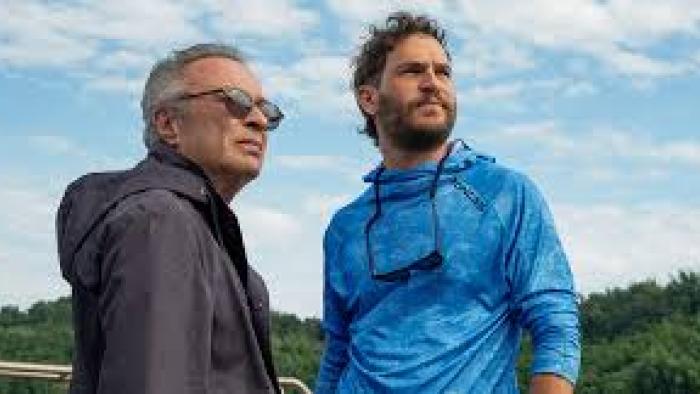 The Giant Falls movie: Two men stand outside