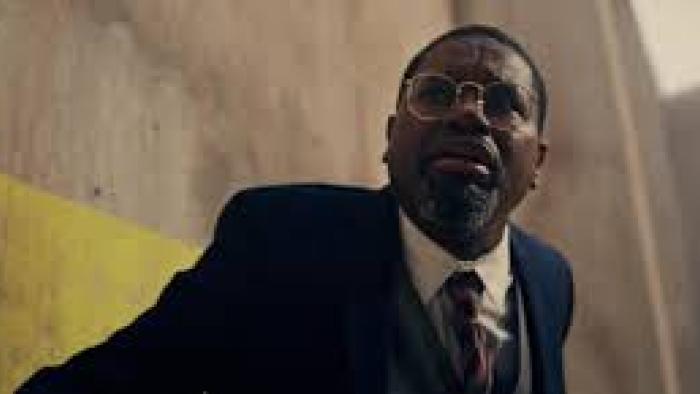 The Mill Movie scene 1: A Black man with glasses in a suit
