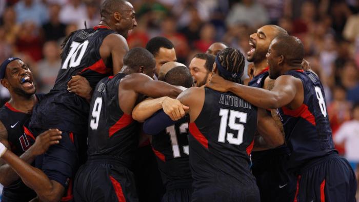 The Redeem Team share a basketball court huddle.