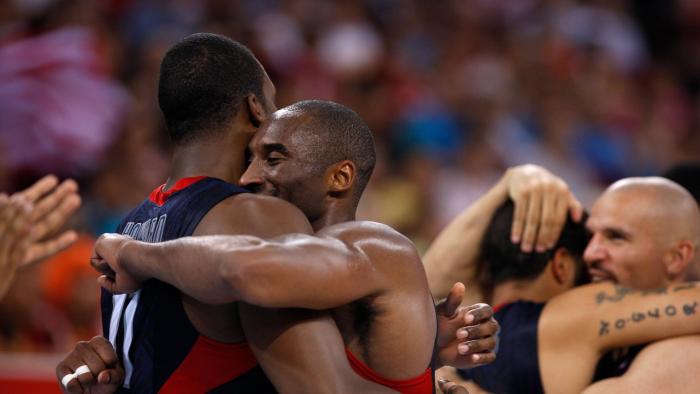 The Redeem Team members Dwight Howard (left) and Kobe Bryant (right) embrace each other on the basketball court.