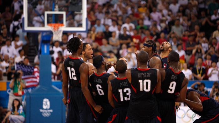 The Redeem Team join in a huddle on the basketball court.