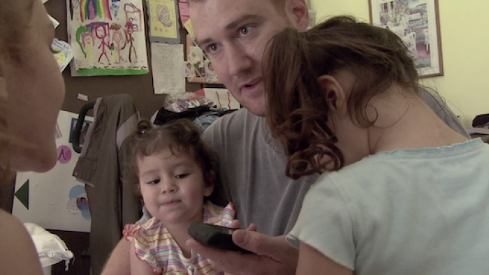 The children talk to their mother on the phone. 