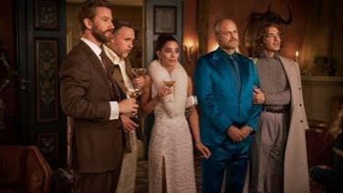 The Storm movie: Five elegantly dressed people standing together in a dimly lit room, holding drinks.