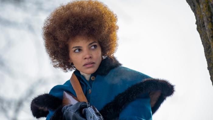 The Thicket Movie: Jimmy Sue (Leslie Grace), holding a rifle at the ready, stalks through the snow