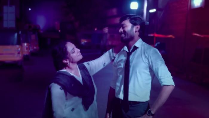 Thiruchitrambalam: An Indian woman smiles at Indian man dressed in a shirt and tie with her hand placed on his shoulder
