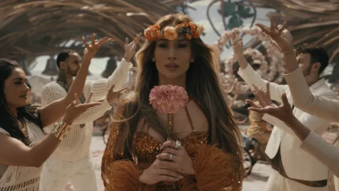 This is Me… Now: A Love Story: Jennifer Lopez holds a flower.