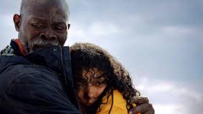 Thrash: Djimon Hounsou holds Whitney Peak.