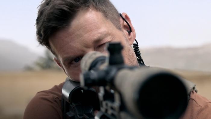 Sniper -- The Last Stand movie: Chad Michael Collins looking down a sniper's rifle
