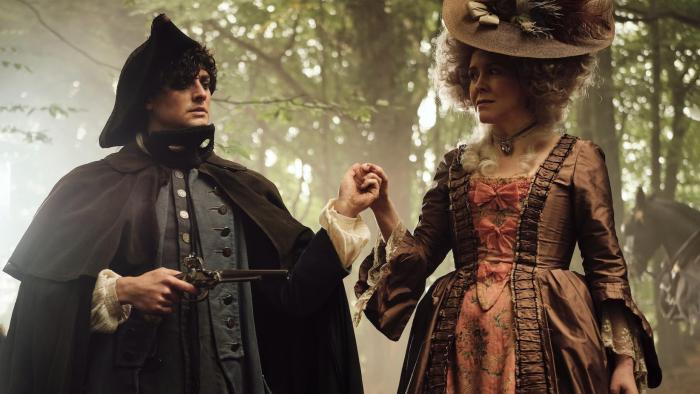 Timestalker: Aneurin Barnard and Alice Lowe stand in a forest holding hands as he points a gun at her