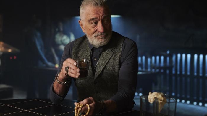 Tin Soldier Movie: Ashburn (Robert De Niro) raises a drink in a bar and looks at someone to his left