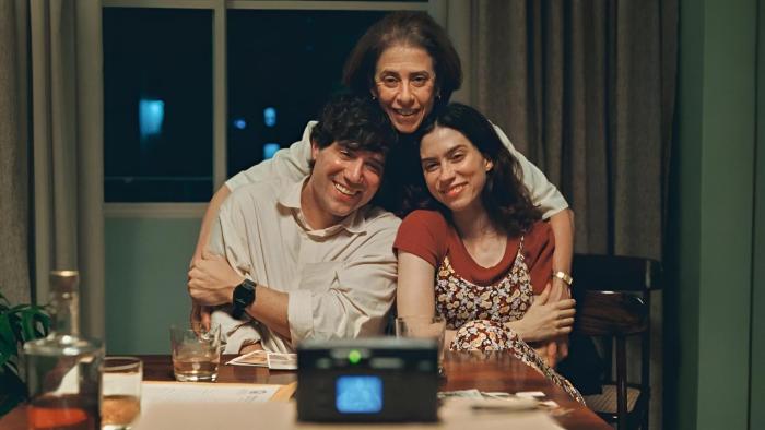 I'm Still Here: A mother holds her two adult children as they pose for a photo