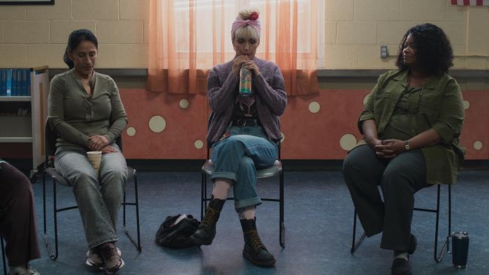Tow movie: Rose Byrne sips an Arizona tea while sitting on folding chairs at an AA meeting