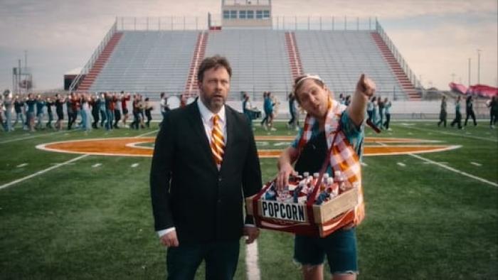 The Great Turkey Town Miracle Movie: Angus Benfield and another man stand on a football field facing the stands