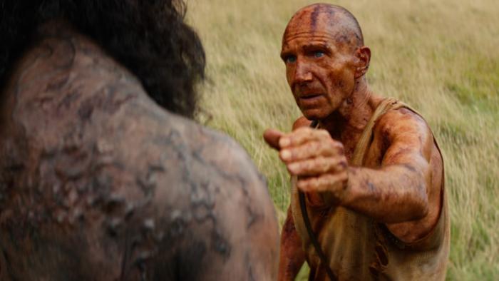 28 Years Later: The Bone Temple Movie: Dr. Ian (Ralph Fiennes) reaches to touch the shoulder of a large alpha zombie