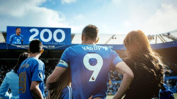 UK Untold: Jamie Vardy: Jamie Vardy in blue soccer jersey standing with family, while the stadium scoreboard shows "200"