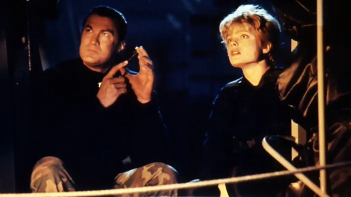 Under Siege: A man holding a pistol and a woman both appear focused and concerned