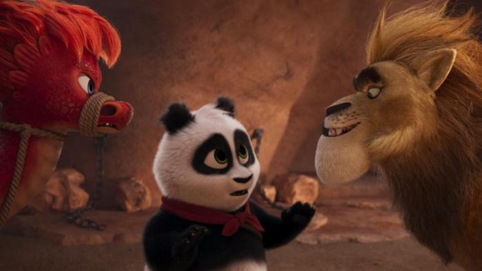 Panda Bear in Africa:  A panda bear talks to a large lion with a calming look on his face. 
