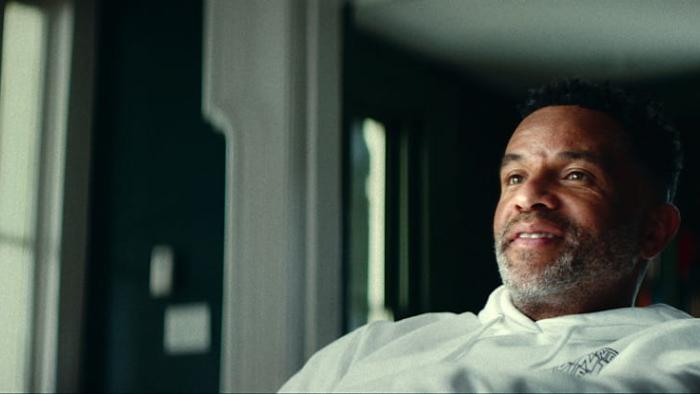 Untold: Jail Blazers movie: Damon Stoudamire leans back and smiles while sitting in a chair