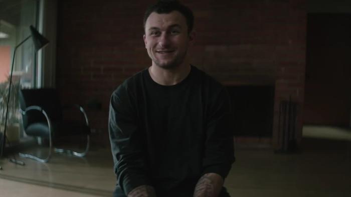 Untold: Johnny Football movie: Johnny Manziel in chair in living room center facing camera