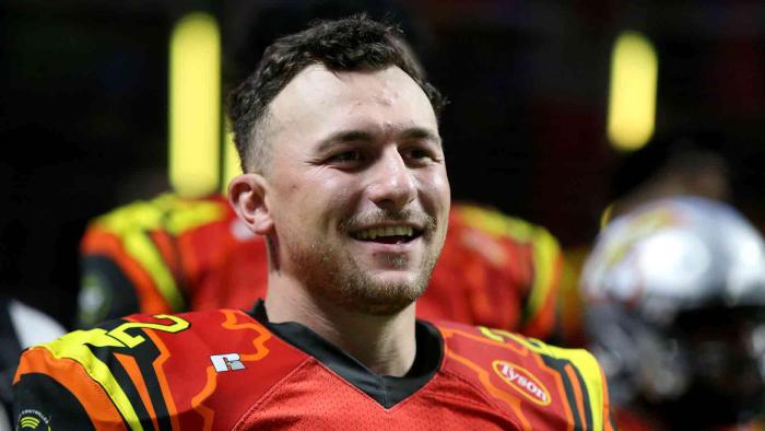 Untold: Johnny Football movie: Johnny Manziel in red and yellow football jersey center