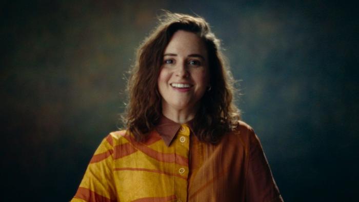 Untold Raygun: Breaking Badly movie: Rachael Gunn sits for her interview in a yellow-orange shirt